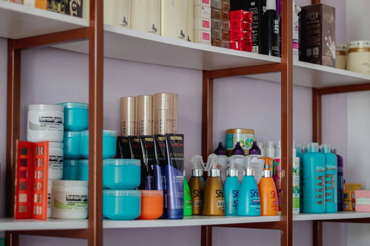 Homemade hair care product line with glass jars of DIY hair masks on wooden table